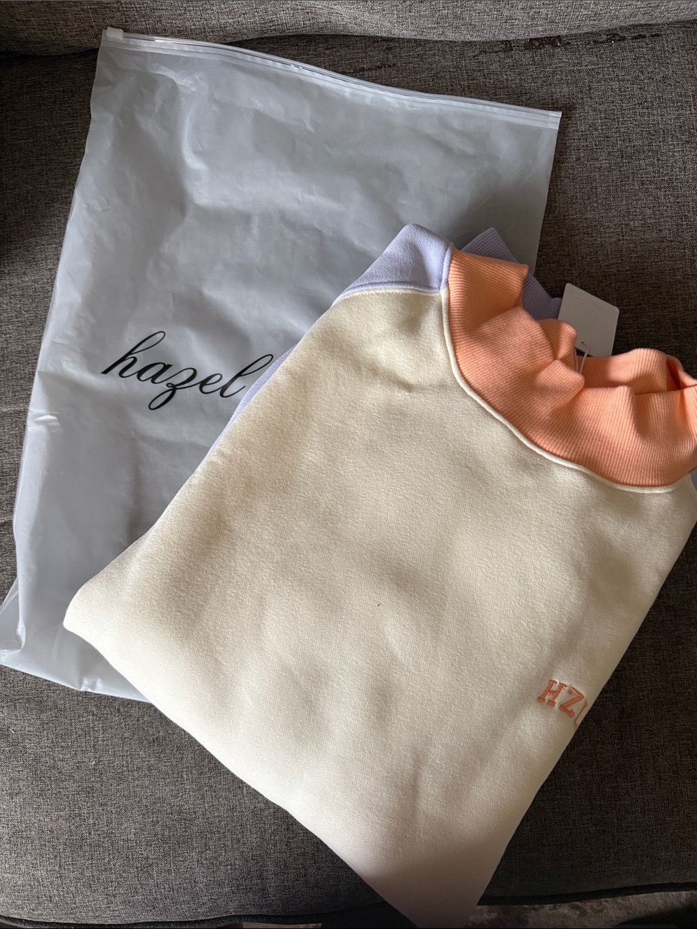 hazel Cream Sweatshirt with Peach Mock Neck and LavenderSleeves.